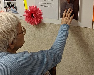 Neighbors | Submitted.Beeghly Oaks wanted to give their residents a fun week to honor them. The workers at the facility made posters describing interesting facts about the residents' lives. Pictured, Helen Horkey admired the picture of herself and her husband on her poster.