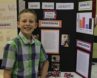 Neighbors | Abby Slanker.A Hilltop Elementary School fourth-grade student conducted a scientific experiment to find out how many licks, based on flavor, it takes to get to the center of a Tootsie Pop for the school’s annual Science Fair on May 25.