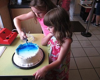 Neighbors | Zack Shively.The Austintown, Canfield and Cornersburg Dairy Queen locations celebrated Father's Day with a decorate your own cake event on June 16. Owner Chrissy Mallory has had the event for many years at her Dairy Queen locations. Pictured, Isabella and Madison Hylton airprushed a cake for their dad.