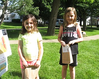 Neighbors | Zack Shively.Poland librarian Vikki Peck organized the Storywalk around the story of "Pete the Cat: Rocking in My School Shoes." The story tied in with the PLYMC's summer reading theme of "Reading Rocks," where they are bridging literacy and music. Pictured, Caroline and Madison Medvec finished the Storywalk.
