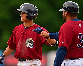 NILES, OHIO - JUNE 21, 2018: Mahoning Valley Scrappers' Tyler Freeman, left, is congratulated by first base coach Omir Santos after a RBI single in the third inning of a baseball game against the Auburn DoubleDays at Eastwood Field in Niles. DAVID DERMER | THE VINDICATOR