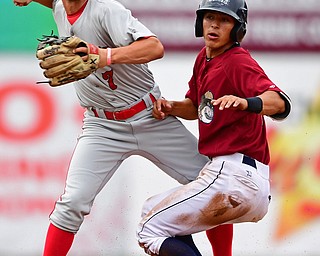 NILES, OHIO - JUNE 21, 2018: Auburn DoubleDays' Cole Daily, left, looks to first after unsuccessfully attempting to force out Mahoning Valley Scrappers' Tyler Freeman in the third inning of a baseball game against the Auburn DoubleDays at Eastwood Field in Niles. DAVID DERMER | THE VINDICATOR