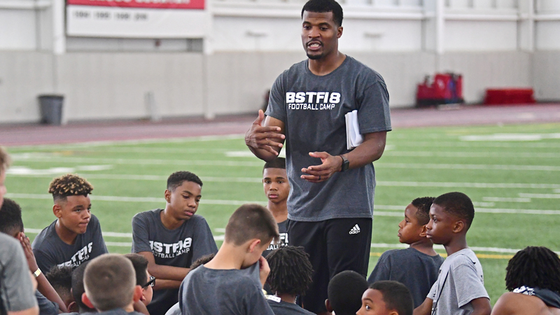 Former NFL wide receiver Brad Smith speaks to the participants of his camp, Saturday morning at the WATTS indoor training facility at Youngstown State University.