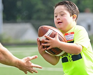 Quintino DeSantis was one of the youngsters who participated in the first day Cardinal Mooney High School's 18th annual Camp of Champions at Cardinal Mooney Football Complex on Monday. Bo Pelini, Youngstown State University head coach, members of his staff and others were on hand to coach students in grades three through eight.