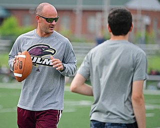 YOUNGSTOWN, OHIO - JUNE 25, 2018: University of Louisiana at Monroe offensive coordinator Matt Kubik demonstrates a technique to the quarterbacks during the Mooney football Camp of Champions, Monday morning at Cardinal Mooney High School. DAVID DERMER | THE VINDICATOR