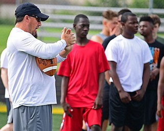 YOUNGSTOWN, OHIO - JUNE 25, 2018: Youngstown State offensive coordinator Brian Crist explains a technique to the receivers during the Mooney football Camp of Champions, Monday morning at Cardinal Mooney High School. DAVID DERMER | THE VINDICATOR