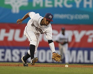 Jose Fermin (12) of the Scrappers charges the ball to make the scoop during Monday evenings matchup against the Williamsport Crosscutters at Eastwood Field in Niles.