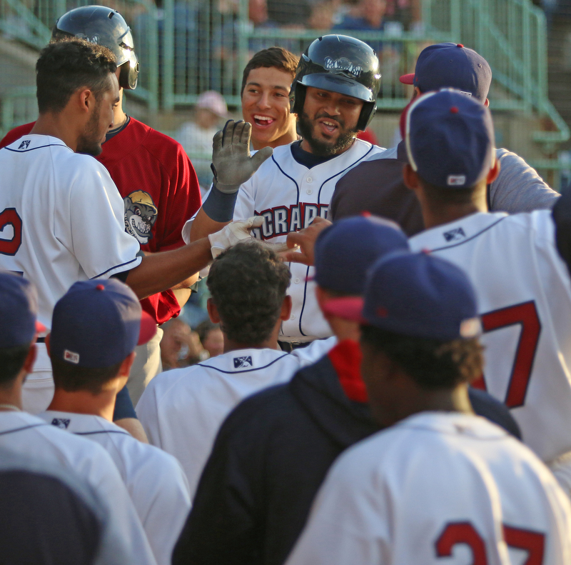 Scrappers catcher Jason Rodriguez (middle) gets greeted by his teammates as he returns to the dugout after hitting a solo home run in the bottom of the third inning during Monday evenings matchup against the Williamsport Crosscutters at Eastwood Field in Niles.
