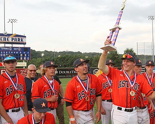 William D. Lewis The Vindicator  Astro Falcon's Craig Palidar(7) hoists the trophy after 6-26-18 win over Avalanche at Cene.