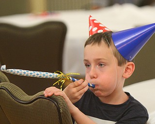 William D. Lewis The Vindicator  Bryce Lasher, 8, enjoys a party favor during Birthday Party for Youngstown at the Tyler History Center 6-27-18. He is a son of Brian/Melissa Lasher of Cortland.