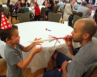 William D. Lewis The Vindicator   Flavio Aiken and his son Gio, 2, share a moment during Birthday Party for Youngstown at the Tyler Historuy Center 6-27-18.