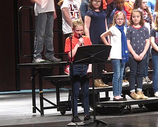 Neighbors | Zack Shively.Different fourth-graders came up to the microphone to introduce the songs that they would sing. They performed a total of seven songs, including "The Star Spangled Banner" to begin the concert.