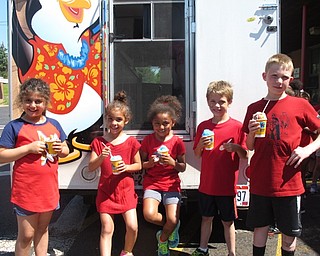 Neighbors | Zack Shively.The St. Christine students participated in a number of activities during the school day, such as playing kickball and jumping in a bounce around. The students cooled off with a frozen treat from Kona Ice.