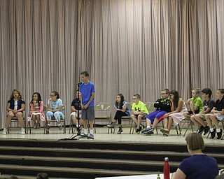 Neighbors | Abby Slanker.A fourth-grade student at Hilltop Elementary School took his turn at the microphone during the school’s annual Fourth-Grade Spelling Bee, as the other contestants looked on.