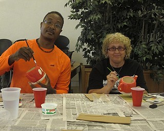 Neighbors | Zack Shively.The Austintown library hosted a "Paint a Planter" event where attendees of the event received free planters and painted them. The library had a number of planters to choose from, including ones shaped as teapots and boots. Pictured, Kevin and Becky Christopher painted their planters in a Mickey and Minnie Mouse style.