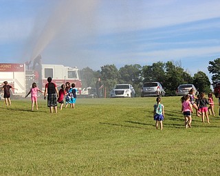 Neighbors | Abby Slanker.The Cardinal Joint Fire District visited the Canfield High School Soccer Boosters’ annual Soccer Kids Camp to cool off the campers by creating a giant sprinkler with their fire hoses on June 14.