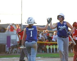 Poland's Mary Brant high-fives Katie McDonald during the district championship game against Canfield on Sunday.