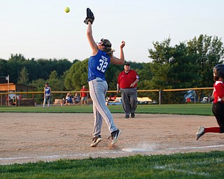 Poland's Sophia Dedo stretches for the ball after Canfield's Gianna Pannanzio runs safely to first during the district championship game on Sunday.