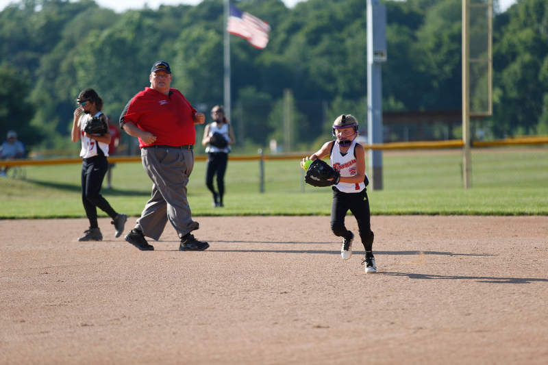 Canfield's Brooke O'Palick runs Austintown's Kaliana Ray back to first during the 10u softball tournament on Sunday.