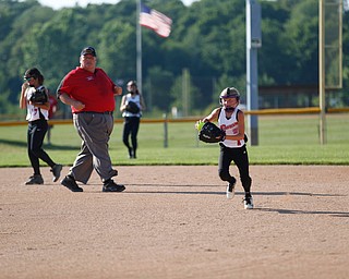 Canfield's Brooke O'Palick runs Austintown's Kaliana Ray back to first during the 10u softball tournament on Sunday.