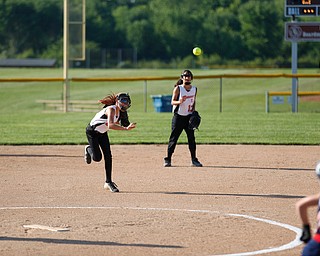 Canfield's Sammi Economous throws the ball to first during the 10u softball tournament against Austintown on Sunday.