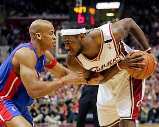 Cleveland Cavaliers' LeBron James, right, stares down Detroit Pistons' Maurice Evans in the second quarter of a second-round NBA basketball playoff game Saturday, May 13, 2006, in Cleveland. (AP Photo/Mark Duncan)