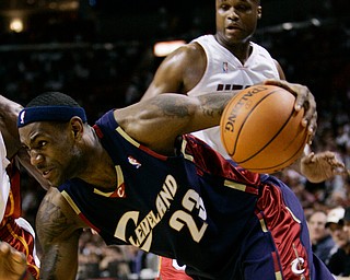 Cleveland Cavaliers' LeBron James (23) drives to the basket as Miami Heat's Antoine Walker looks on in the second quarter of a basketball game in Miami, Thursday, Feb. 1, 2007. (AP Photo/Alan Diaz)