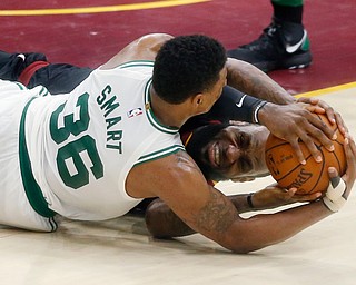 Cleveland Cavaliers' LeBron James, rear, and Boston Celtics' Marcus Smart battle for the ball during the second half of Game 6 of the NBA basketball Eastern Conference finals  Friday, May 25, 2018, in Cleveland. The Cavaliers won 109-99. (AP Photo/Ron Schwane)