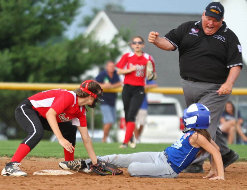 William D. Lewis The Vindicator Umpire Mike Williams calls Poland's (14) out. Making the tag for canfield is (21)  during 7-2-18 win over Poland at Fields of Dreams.