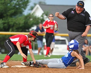 William D. Lewis The Vindicator Umpire Mike Williams calls Poland's (14) out. Making the tag for canfield is (21)  during 7-2-18 win over Poland at Fields of Dreams.