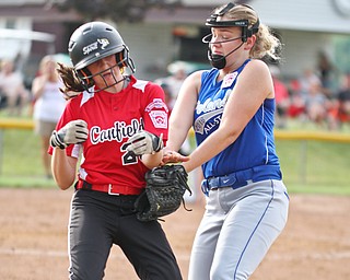 William D. Lewis The Vindicator  Canfield's (23) is safe at first while Poland's (32)  tries to make the tag during 7-2-18 win over Poland at Fields of Dreams.