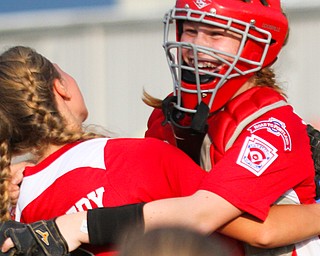 Canfield 12U softball players celebrate after defeating Poland at Fields Of Dreams in Boardman on Monday.