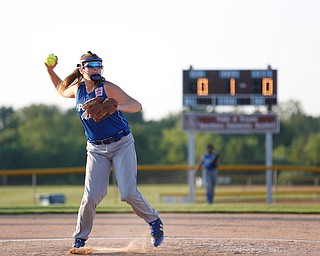 Katie McDonald, a pitcher for Poland's 12u softball team, throws the ball to first during the first inning of the district championship game against Canfield on Sunday.