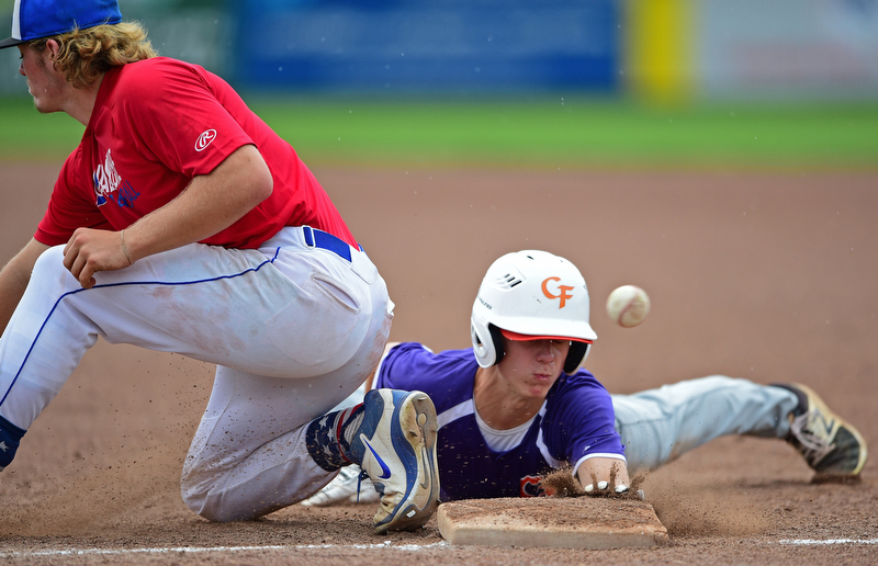 STRUTHERS, OHIO - JULY 3, 2018: Creekside' Kyle Weitzel dives into first while Avalanche' Jamin Wentling misplays the ball in the second inning of a baseball game, Tuesday, July 3, 2018 in Struthers. Weitzel would advance to second. DAVID DERMER | THE VINDICATOR