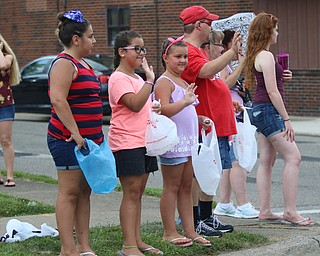 Sofie Previte (10) of Struthers, Zoe Crespo (9), and Gia Crespo (7) of Boardman wave to the floats as they go by during the Struthers Fourth of July Parade on Wednesday afternoon.  Dustin Livesay  |  The Vindicator  7/4/18  Struthers