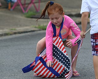 Brynn Capelli (7) of Boardman grabs candy during the Struthers Fourth of July Parade on Wednesday afternoon.  Dustin Livesay  |  The Vindicator  7/4/18  Struthers