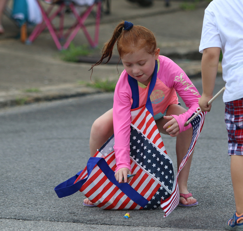Brynn Cappelli (7) of Boardman grabs candy during the Struthers Fourth of July Parade on Wednesday afternoon.  Dustin Livesay  |  The Vindicator  7/4/18  Struthers