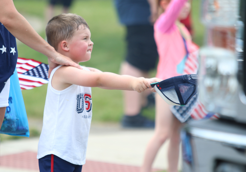 Colin Hallquist (4) of Struthers holds out his hat for candy during the Struthers Fourth of July Parade on Wednesday afternoon.  Dustin Livesay  |  The Vindicator  7/4/18  Struthers