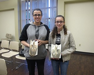 Neighbors | Zack Shively.The Boardman library had a book folding program at their branch. The attendees folded pages in books to create a special fleur-de-lis design. Pictured are, from left, Lana Ilain and Serene Awad with their finished products.