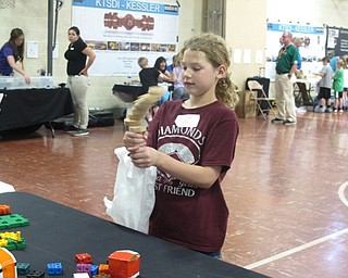 Neighbors | Zack Shively.All of the students at Stadium Drive Elementary got to participate in the STEM event for at least 85 minutes. They spent from five to six minutes at each of the stations in the school's gym and near the front of the building. Pictured is Adelynn Rudge playing with one of the pieces of equipment brought by the science center.
