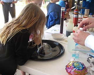 Neighbors | Zack Shively.KTSDI brought in a STEM event to get students interested in the STEM field at a younger age. The program married STEM learning (science, technology, engineering and mathematics) with fun activities. Pictured, a Stadium Elementary student blew a bubble at an activitie station from YSU's chemistry department.