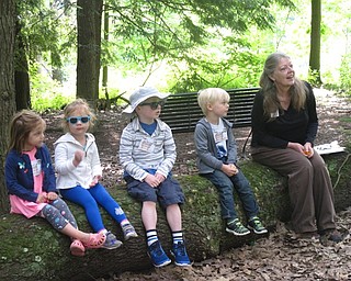 Neighbors | Zack Shively.Children sat with naturalist Marilyn Williams during the "Quiet in the Garden" program to look and listen for different animals, such as birds. Pictured, children Caroline Roman, Karlee Roman, Danny Ogonek and Braunson Craft sit on a log with Williams.