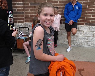 Neighbors | Zack Shively.Dobbins Elementary celebrated the end of the school year with a fun day on June 3. The students had the chance to play at a series of different stations, such as spray-on tattoos. Pictured, Leah Vestal posed to display her dolphin tattoo.