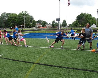 Neighbors | Zack Shively.The Dobbins Elementary students played a number of games at the high school's football field. They set up multiple stations where the students moved between. Pictured, the students and staff played a game of tug-of-war.