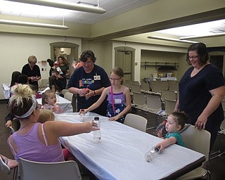 Neighbors | Jessica Harker.A Boardman librarian helped add tape to the tops of the childrens shakers at the Boardman library on June 20.