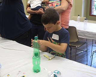 Neighbors | Jessica Harker.Gus Glenellen decorated his shaker with stickers at the Rock Out with the Green Team event at the Boardman library.