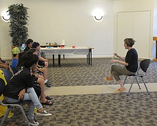 Neighbors | Jessica Harker .An Austintown librarian read "Water Can Be," to the group of children and their family on June 27.