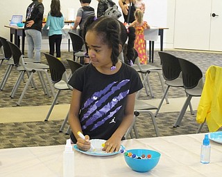 Neighbors | Jessica Harker .Anani Lawerence decorated her coffee filter at the "Water Diffusing" station on June 27.