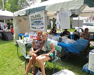 Neighbors | Jessica Harker.Hayley Ho and Grace Scheck, both incoming freshman at Poland Seminary High School, volunteered to paint faces to benefit the school's swim team during Celebrate Poland.