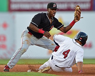 NILES, OHIO - JULY 6, 2018: Batavia Muckdogs' Demetrius Sims looks before unsuccessfully applying a tag to Mahoning Valley Scrappers' Tre Gantt after Batavia Muckdogs' Albert Guaimaro dropped the ball in the third inning of a baseball game against the Batavia Muckdogs, Friday, July 6, 2018, in Niles. DAVID DERMER | THE VINDICATOR